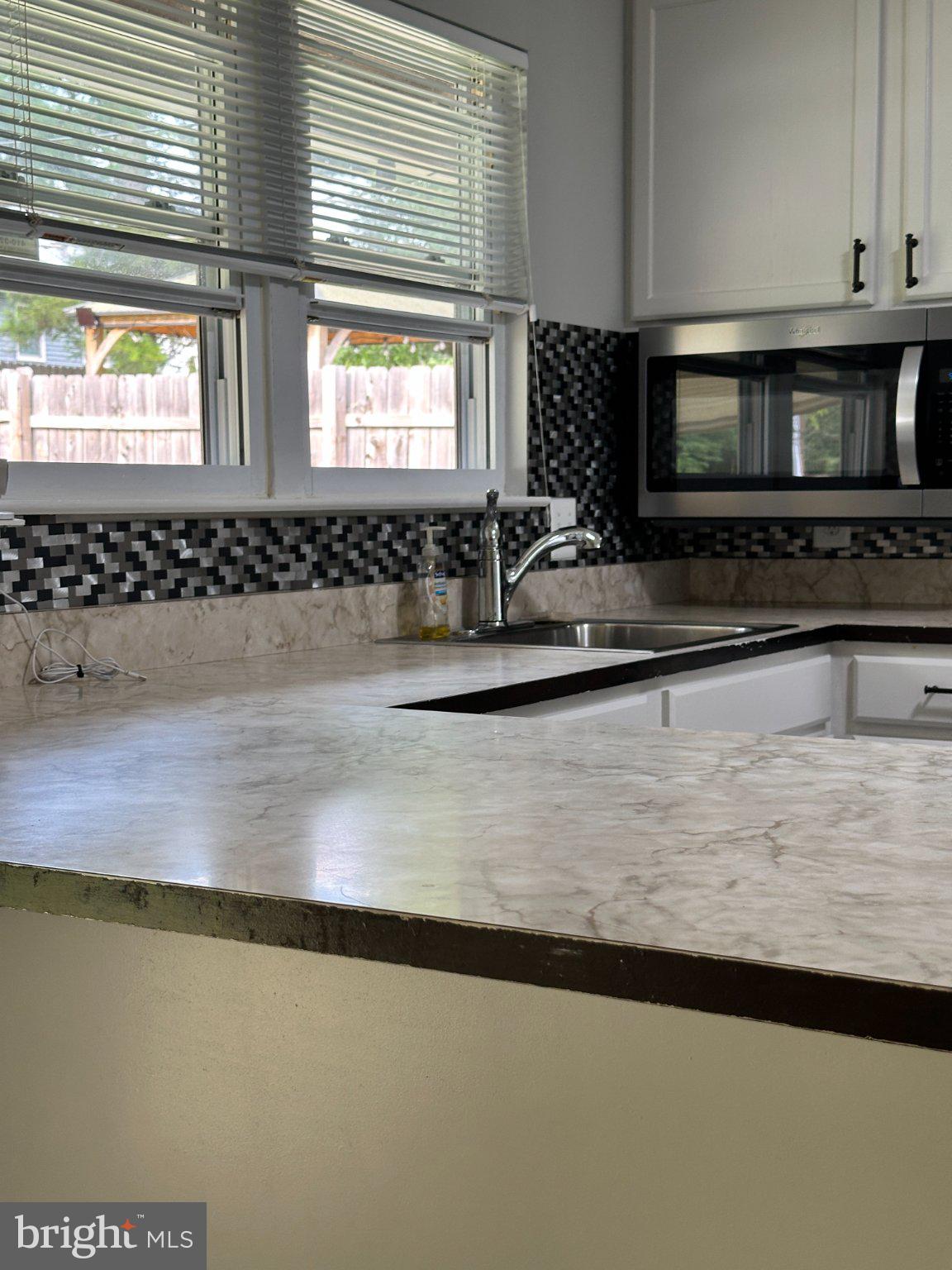 8336 Scotts Level Road Baltimore, MD 21208 - Photo 21 of 55 Modern kitchen with sleek finishes.