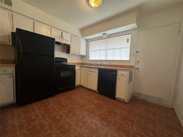 a kitchen with a refrigerator and a sink