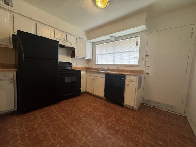 a kitchen with a refrigerator and a sink