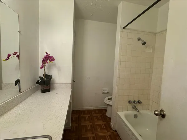 a bathroom with a tub and shower