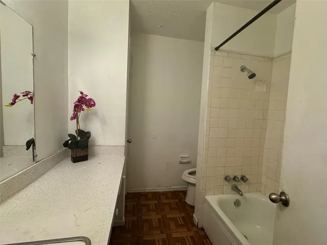 a bathroom with a tub and shower