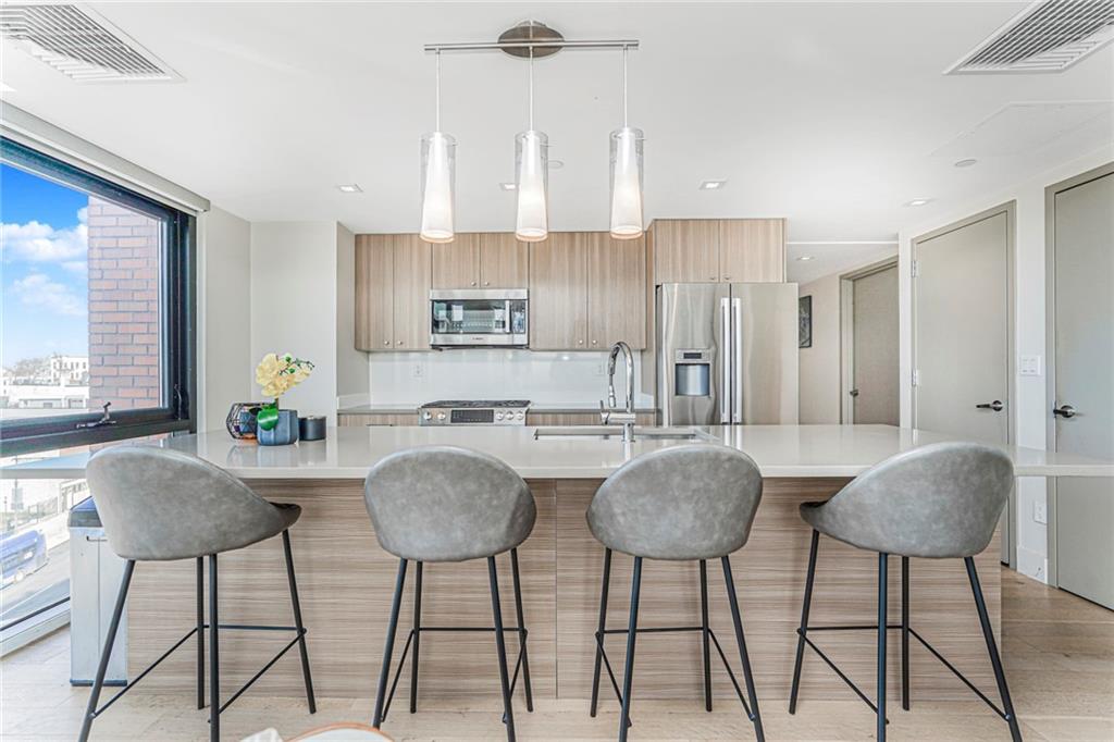 a view of kitchen with dining area and chandelier