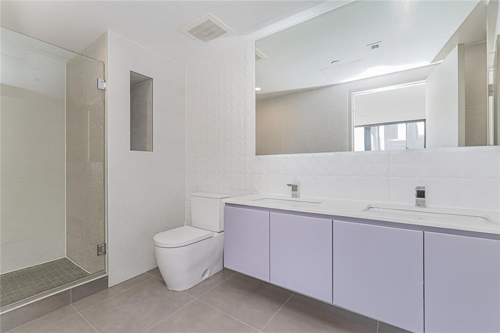 401 95th Street, Unit 6A Brooklyn, NY 11209 - Photo 13 of 24 a bathroom with a toilet sink and mirror