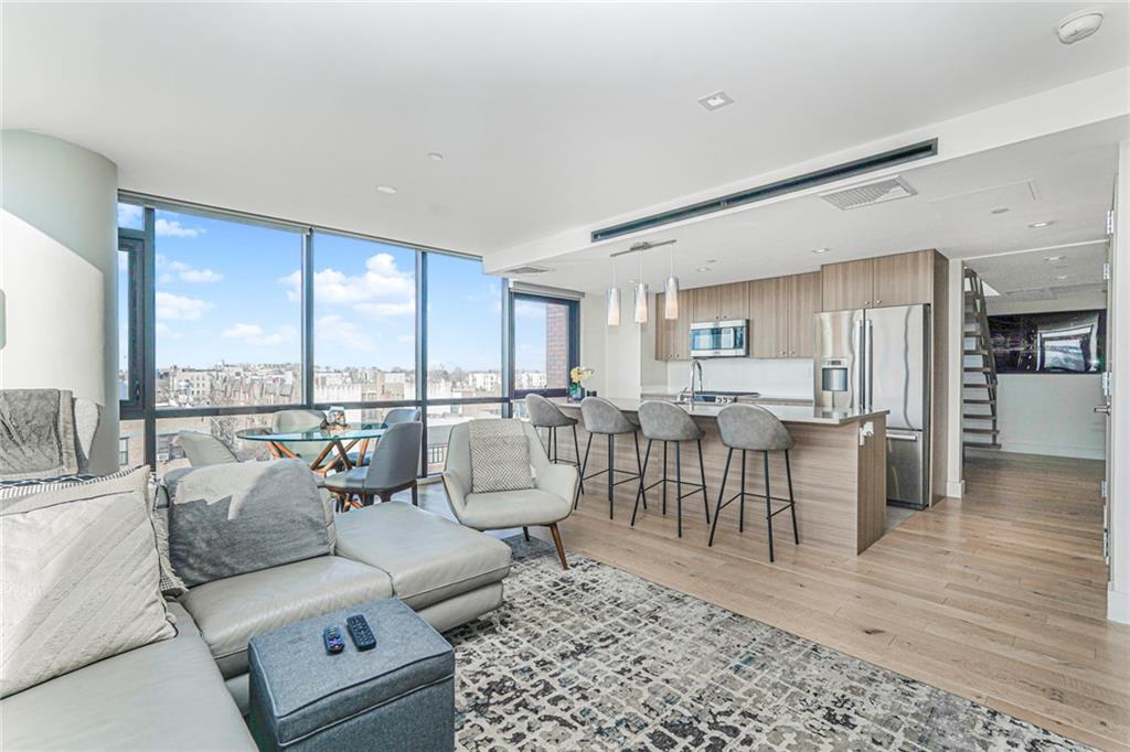 401 95th Street, Unit 6A Brooklyn, NY 11209 - Photo 8 of 24 a living room with furniture and a table