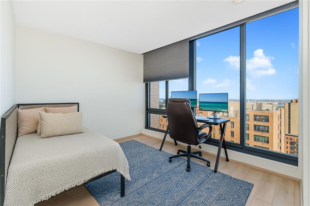 401 95th Street, Unit 6A Brooklyn, NY 11209 - Photo 10 of 24 a bedroom with a bed a desk and chair with the wooden floor