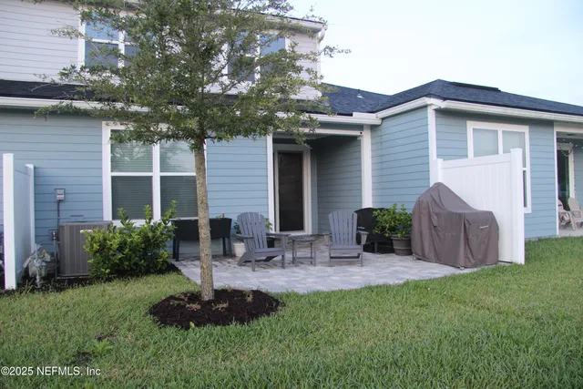 a front view of house with yard and outdoor seating