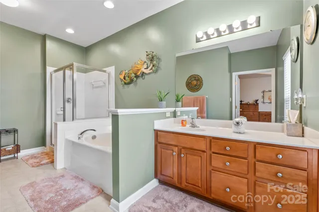 a spacious bathroom with a double vanity sink mirror and bathtub