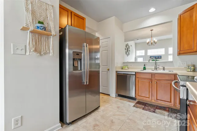 a kitchen with stainless steel appliances granite countertop a refrigerator and a sink