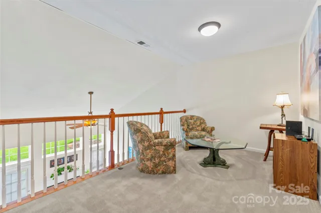 a living room with furniture and a lamp