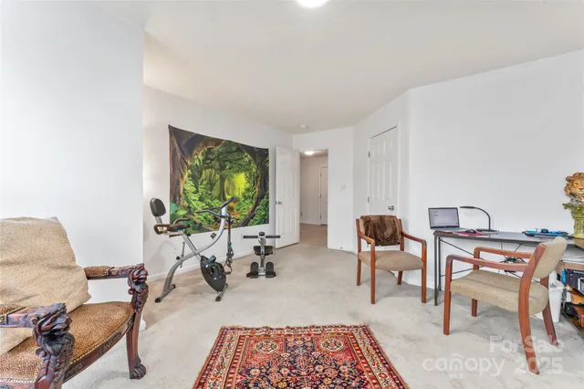 a living room with furniture a window and a flat screen tv