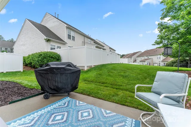 a view of backyard with outdoor seating and green space