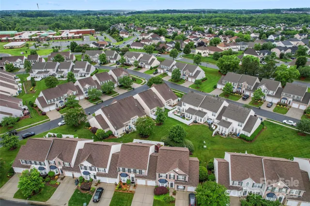 an aerial view of residential houses with outdoor space and street view