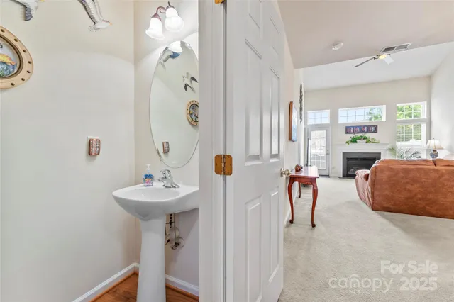 a living room with furniture a fireplace and a chandelier