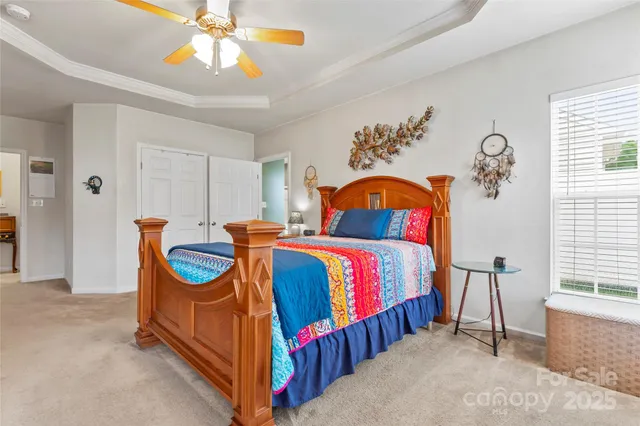 a bedroom with bed and a chandelier
