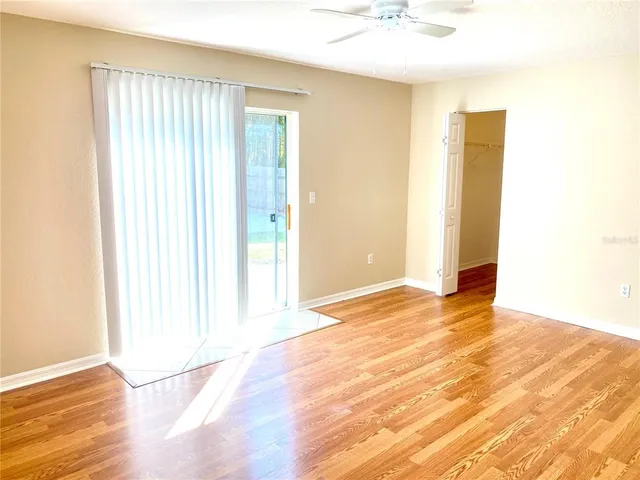 a view of an empty room with wooden floor