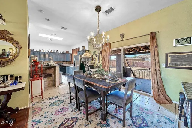 a view of a dining room with furniture and chandelier