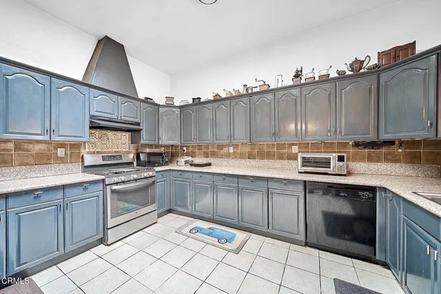 a kitchen with stainless steel appliances granite countertop a sink and cabinets