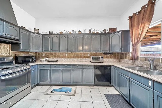 a kitchen with a sink stove and cabinets
