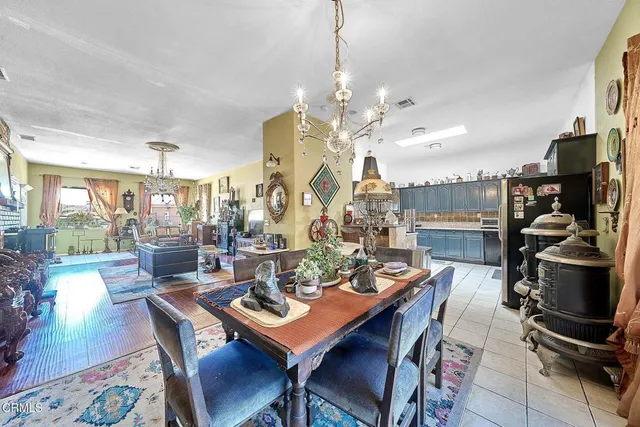 a view of a dining room with furniture a chandelier and wooden floor