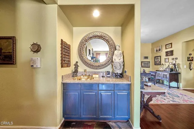 a living room with a sink and a mirror