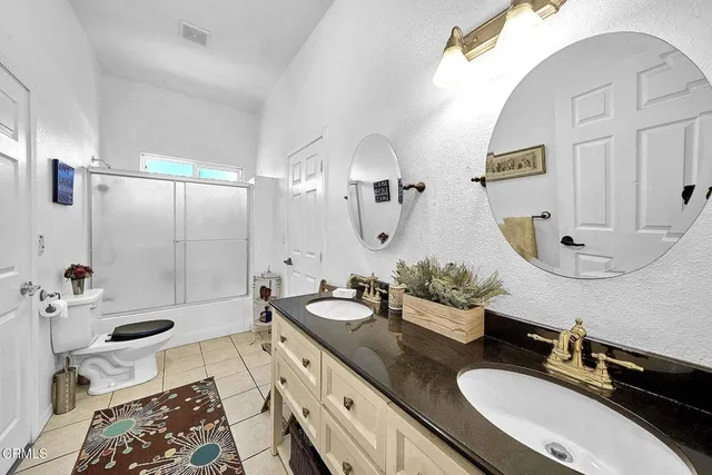 a bathroom with a granite countertop sink mirror and vanity
