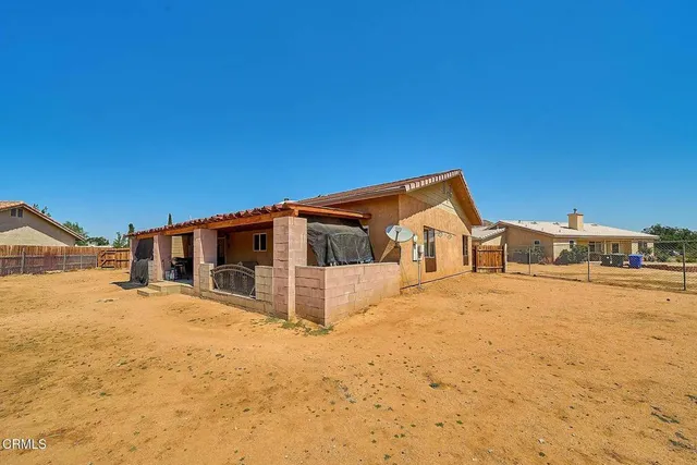 a front view of a house with a yard covered in snow