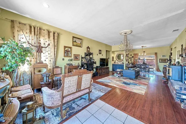 a living room with fireplace furniture and a wooden floor