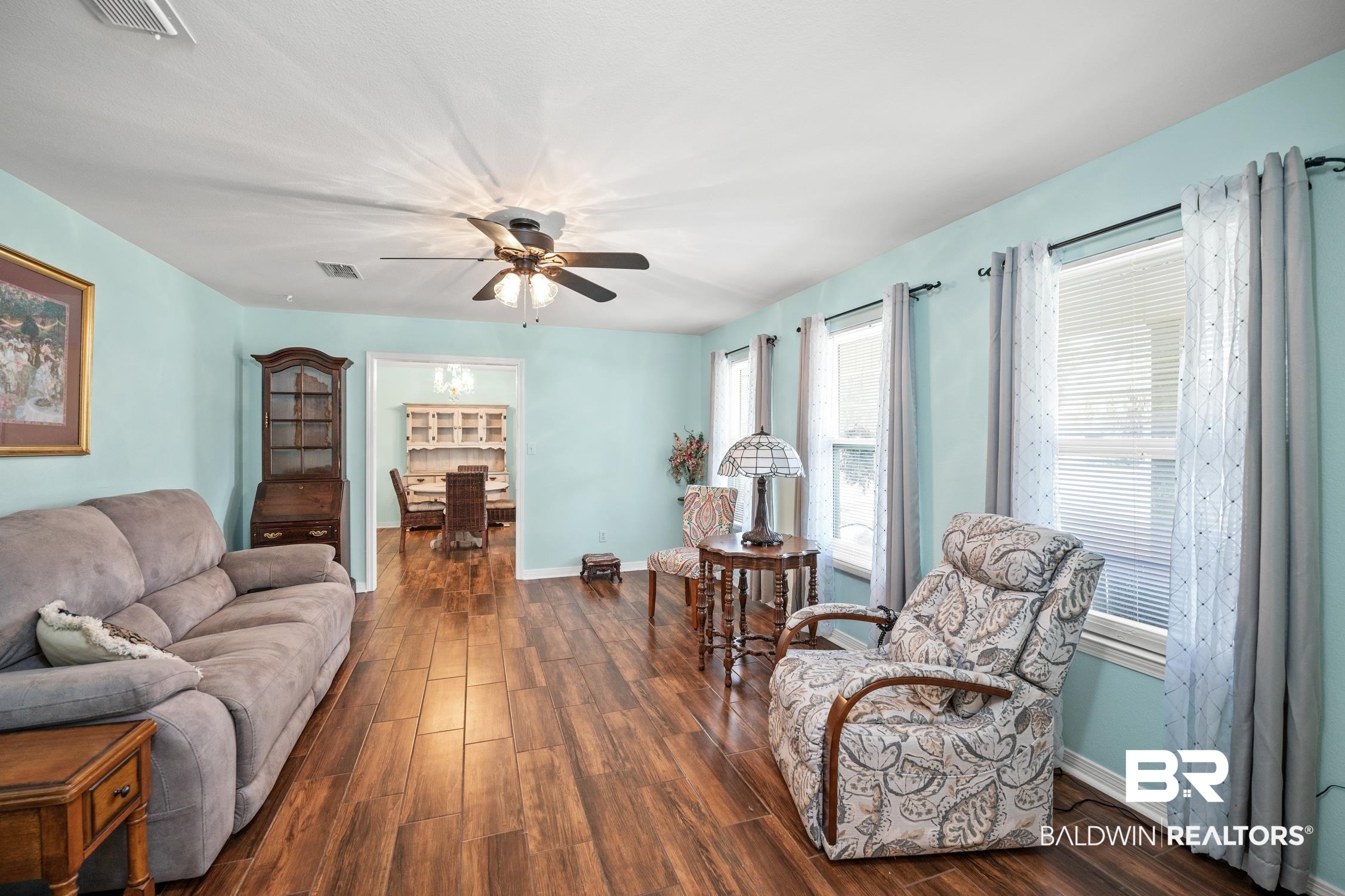 2553 Santa Rosa Drive Lillian, AL 36549 - Photo 10 of 51 Living area with baseboards, visible vents, dark wood finished floors, and a ceiling fan
