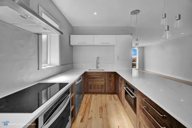a kitchen with sink and cabinets