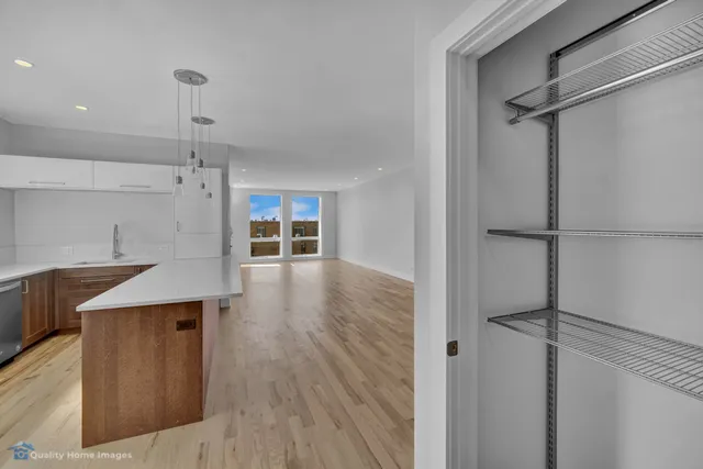 a view of a kitchen with a wooden floor and a window