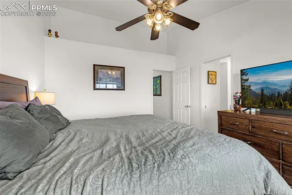 a bedroom with a bed and a chandelier
