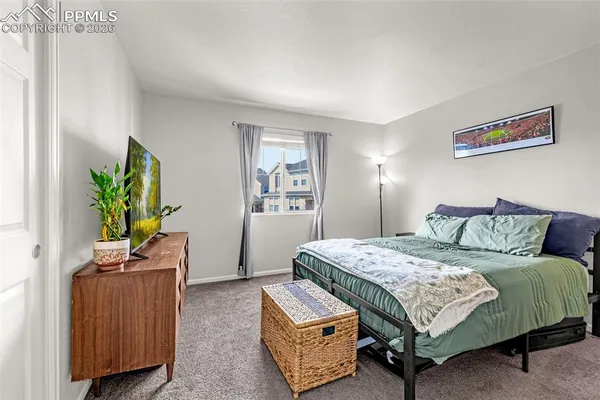 a bedroom with a bed and a dresser in it