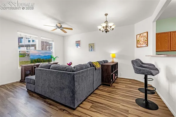 a living room with furniture and a chandelier