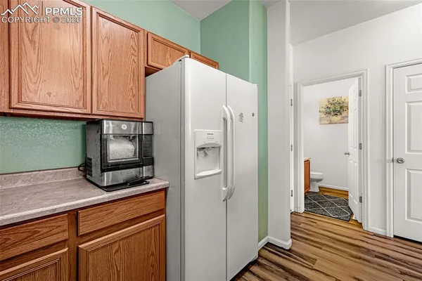 a kitchen with a refrigerator and cabinets