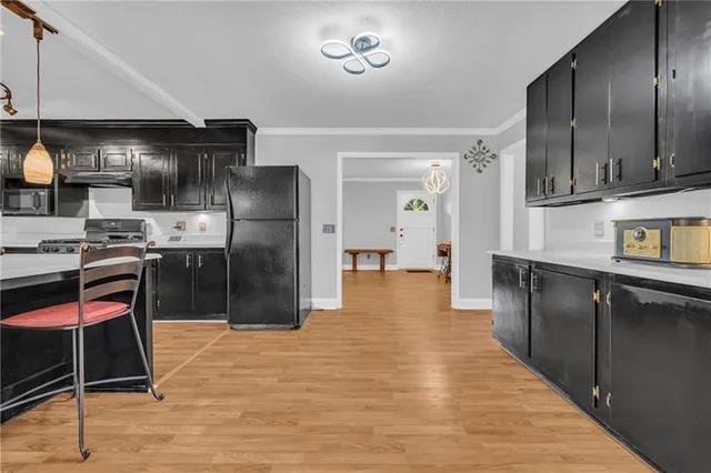 a living room with fireplace furniture and a large window