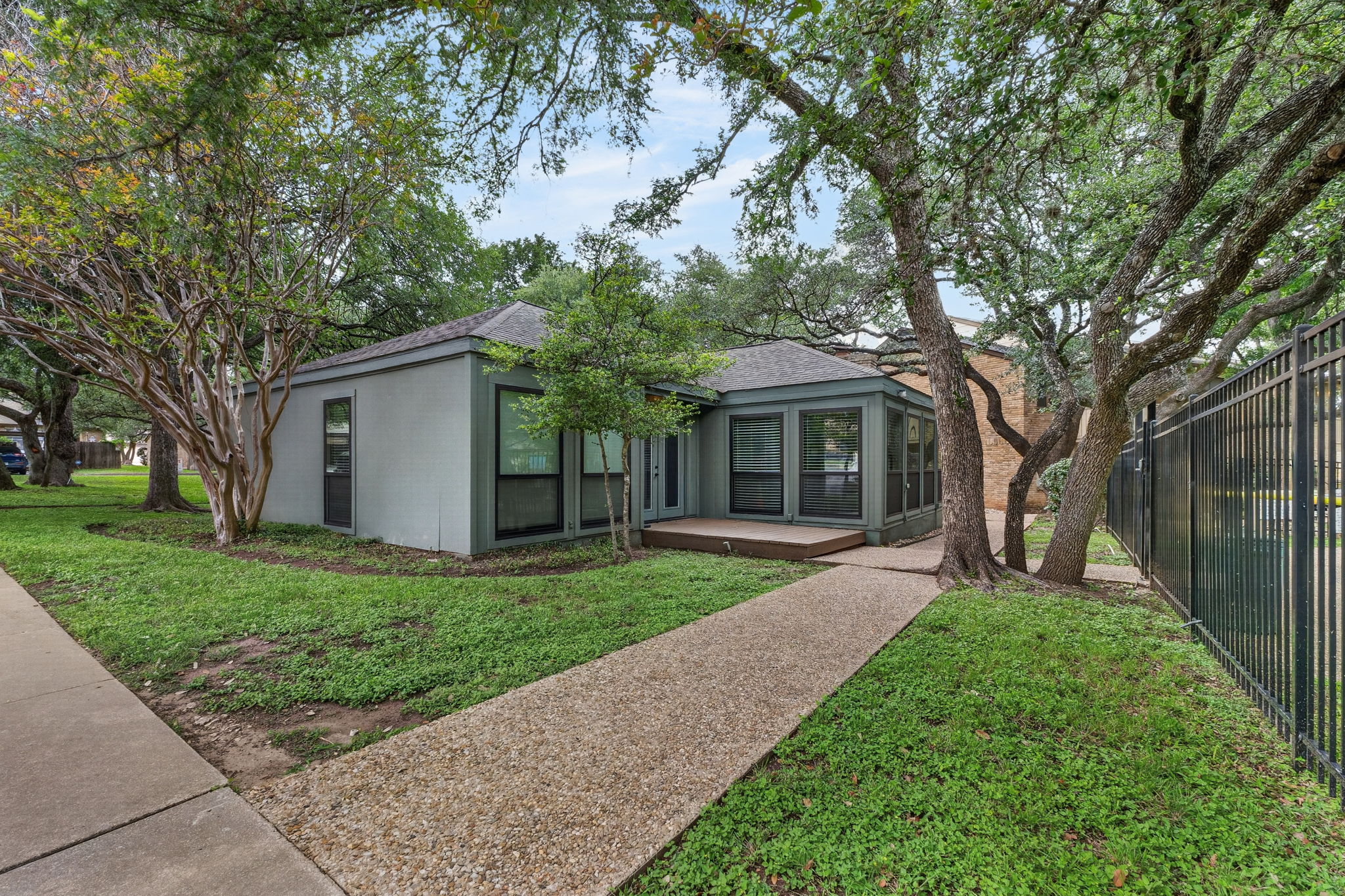 8210 Bent Tree Road, Unit 256 Austin, TX 78759 - Photo 28 of 29 a front view of a house with a yard and large trees