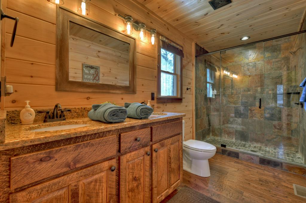 136 Oasis Drive Blue Ridge, GA 30513 - Photo 23 of 47 a bathroom with a sink a toilet and shower