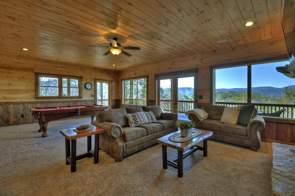 136 Oasis Drive Blue Ridge, GA 30513 - Photo 37 of 47 a living room with furniture a ceiling fan and a large window