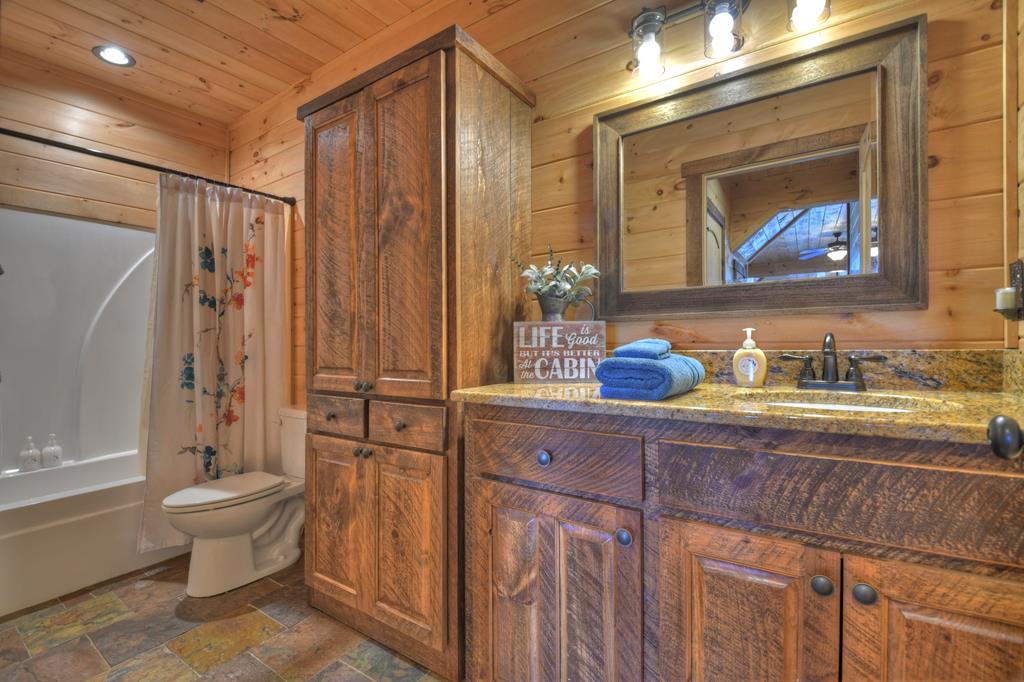 136 Oasis Drive Blue Ridge, GA 30513 - Photo 41 of 47 a bathroom with a granite countertop sink toilet and shower