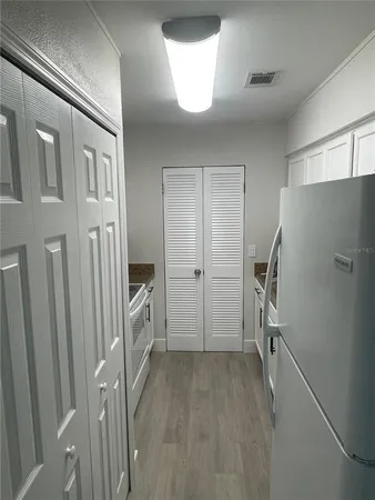 a view of a kitchen with a refrigerator a sink and dishwasher refrigerator