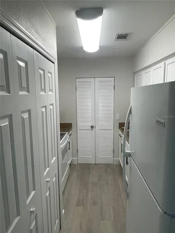 a view of a kitchen with a refrigerator a sink and dishwasher refrigerator