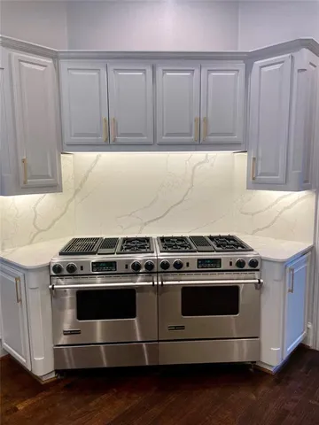 a stove top oven sitting inside of a kitchen