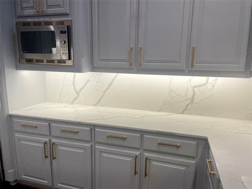 4139 Herschel Avenue Dallas, TX 75219 - Photo 15 of 30 a close view of a sink a cabinet and a flat screen tv