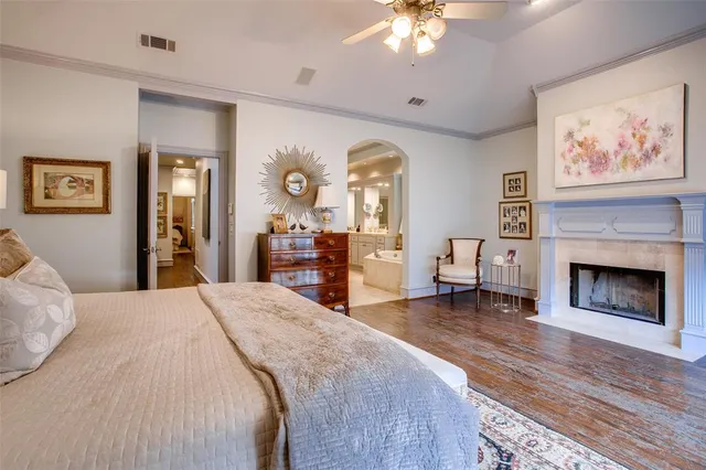 a spacious bedroom with a bed and a fireplace