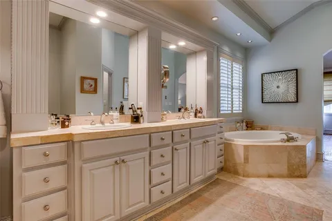 a spacious bathroom with a double vanity sink mirror and double