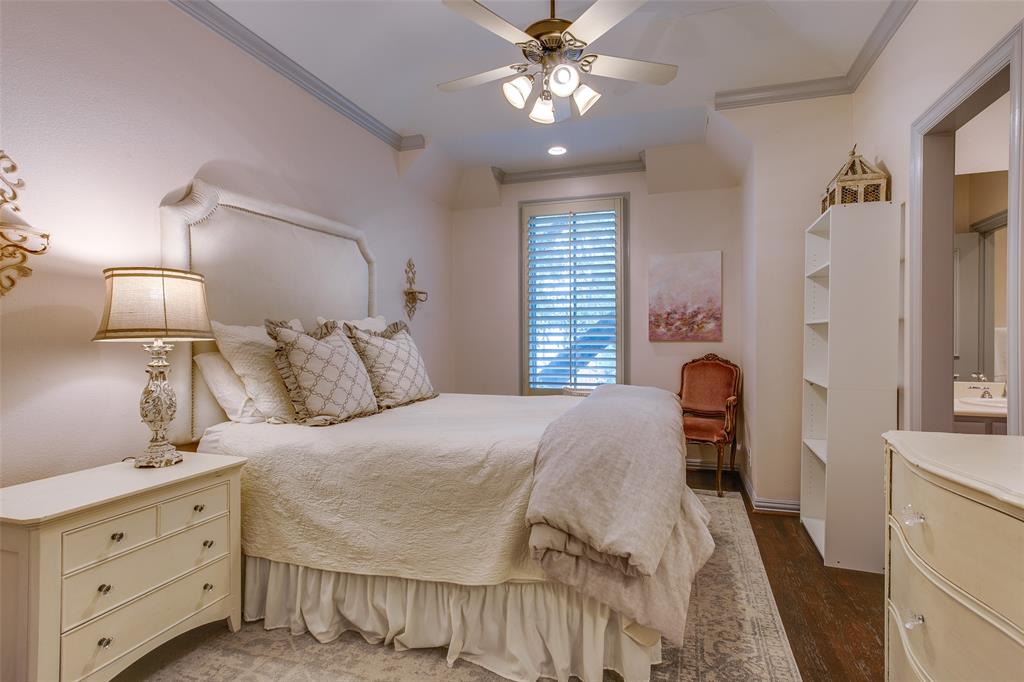 4139 Herschel Avenue Dallas, TX 75219 - Photo 23 of 30 a bedroom with a bed and a chandelier