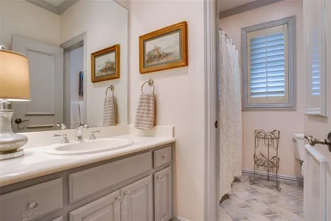 a bathroom with a sink a toilet and a mirror