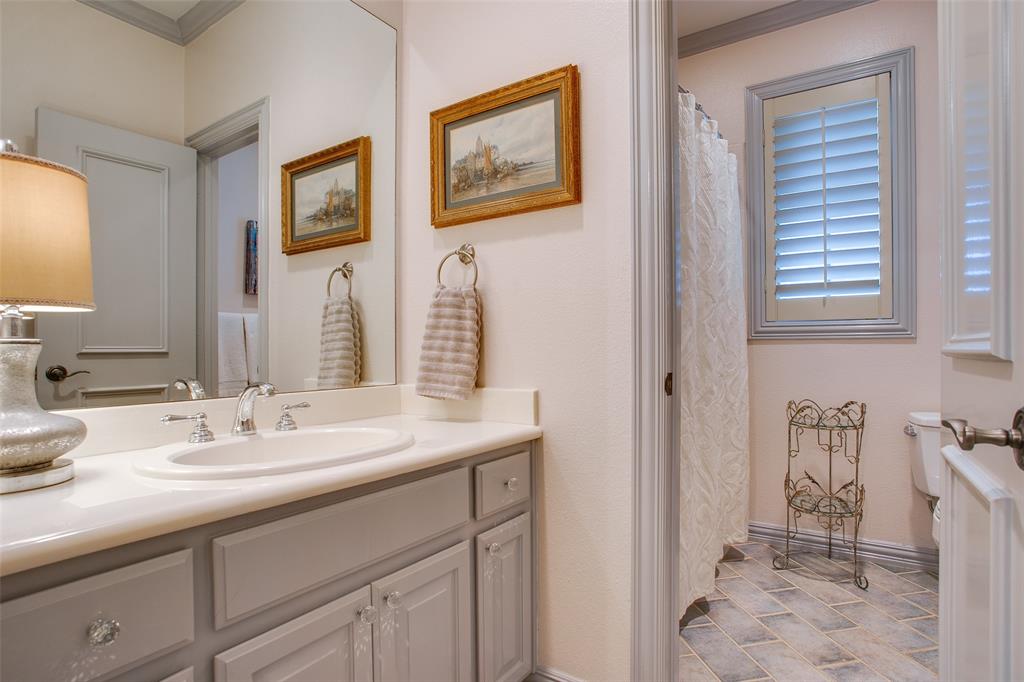 4139 Herschel Avenue Dallas, TX 75219 - Photo 24 of 30 a bathroom with a sink a toilet and a mirror