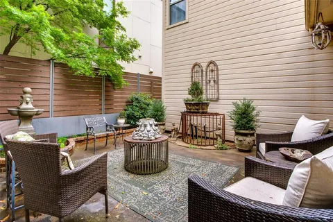 a view of a patio with couches chairs and potted plants