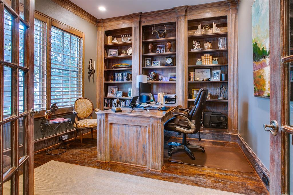 4139 Herschel Avenue Dallas, TX 75219 - Photo 7 of 30 a view of a workspace with furniture and a bookshelf